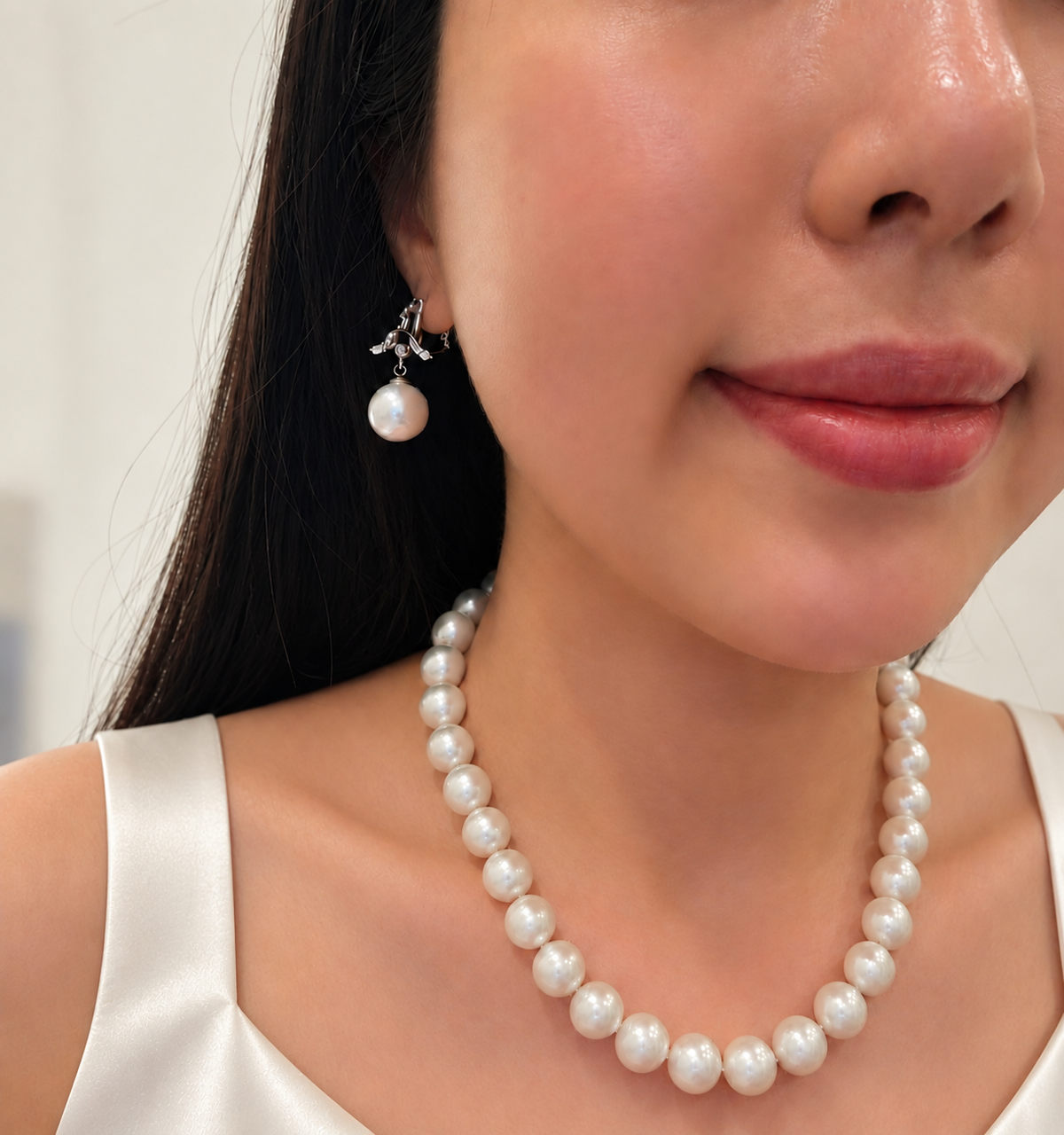 Amber Choice freshwater pearl necklace and pearl earrings styled with an ivory silk top