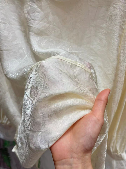 Close-up of the blouse's softly shimmering fabric