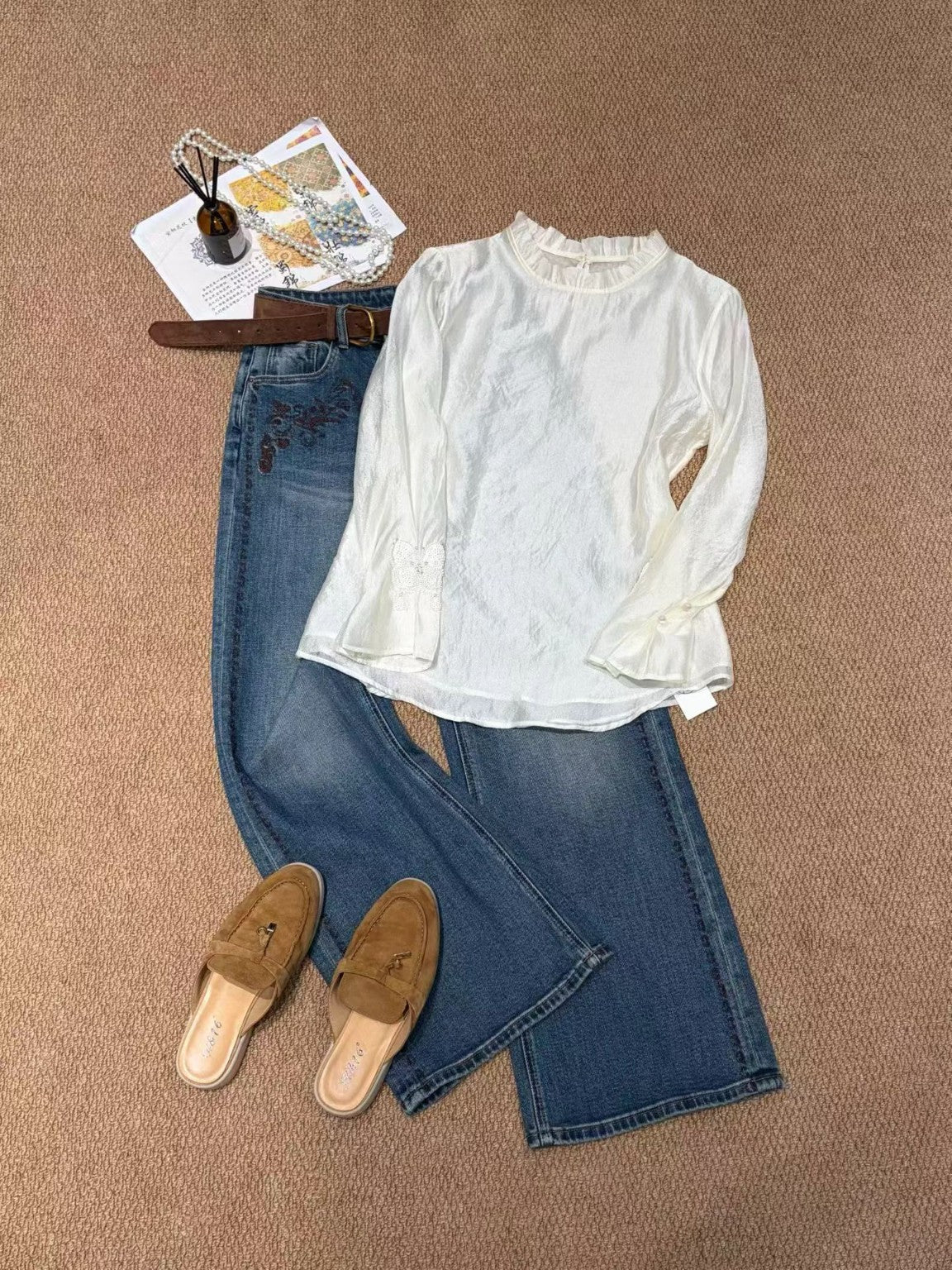 White butterfly embellished blouse styled with jeans