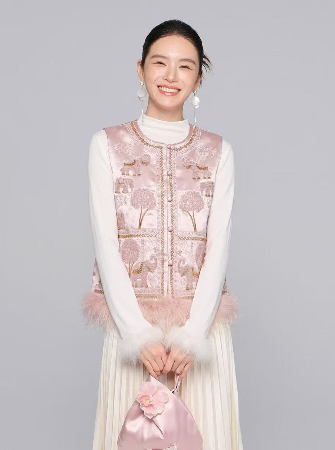 Blush pink embroidered elephant motif vest, model view