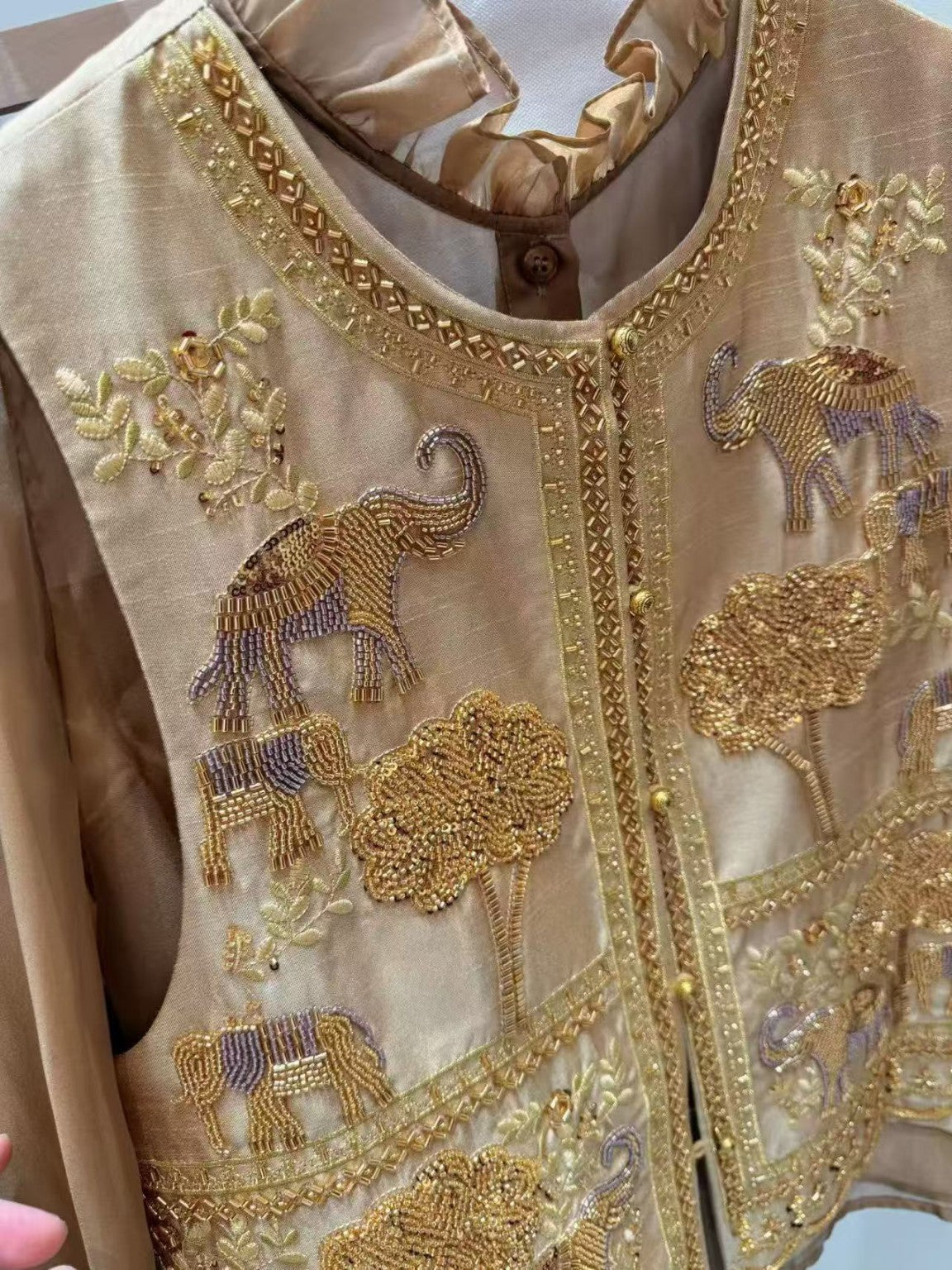 Detailed embroidery and beadwork on the vest