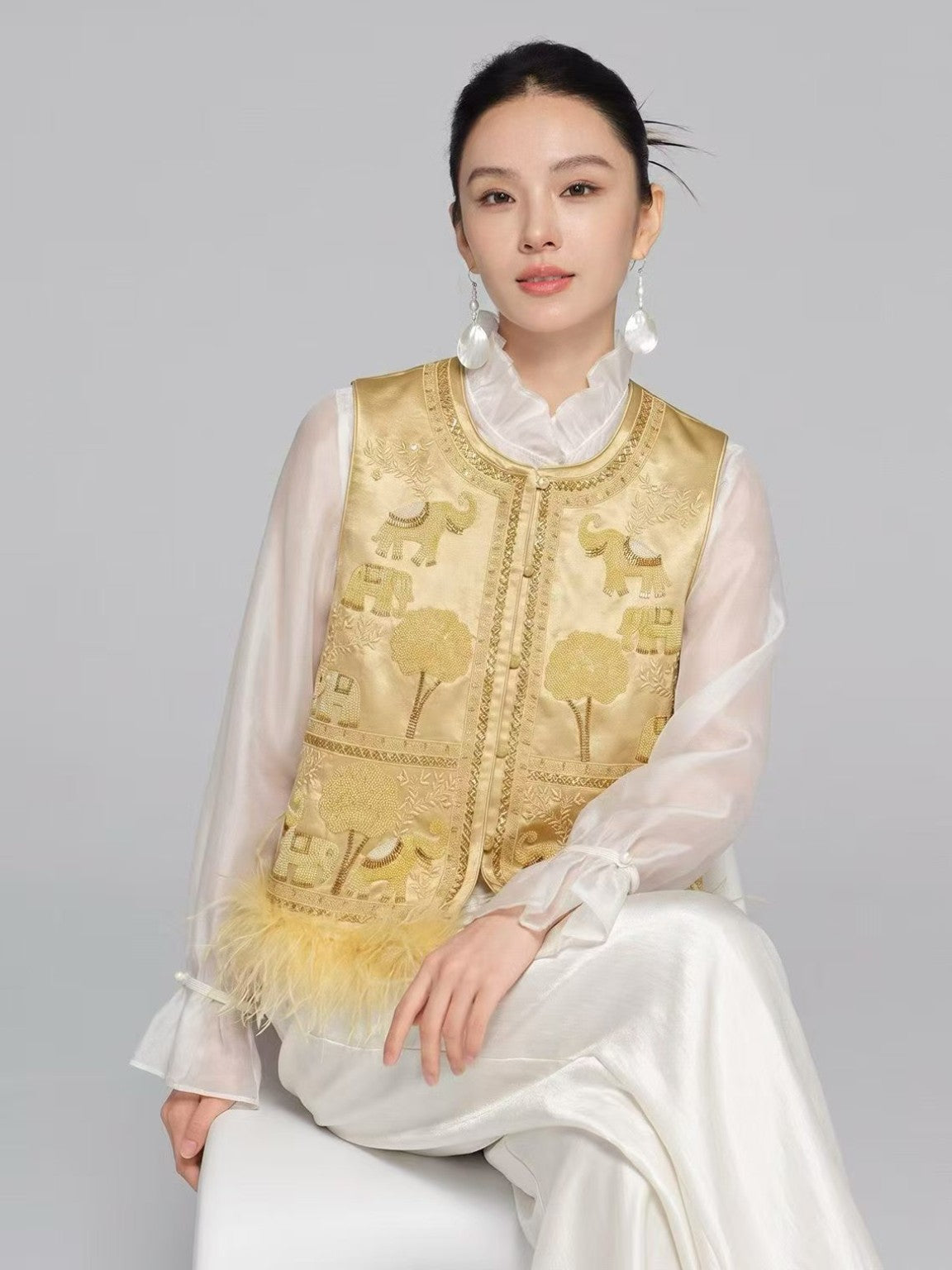 Champagne gold embroidered elephant motif vest, model view